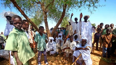 Displaced Sudanese wave as they wait for the arrival of Sudan's prime minister a camp for internally displaced people (IDP) in El-Fasher, the capital of the North Darfur state. AFP