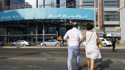 Pedestrians illegally cross the street in front of Abu Dhabi Mall even though a steel footbridge has been specially built for their use to allow them to safely cross the busy multilane roadway outside the popular shopping destination. Antonie Robertson / The National