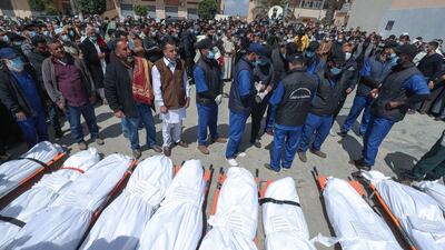 Libyans take part in a funeral procession for 12 bodies found in mass graves in Tarhuna. AFP