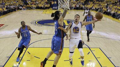 Stephen Curry drives to the basket as Oklahoma City Thunder's Steven Adams defends during the first half in Game 2. Marcio Jose Sanchez / AP Photo