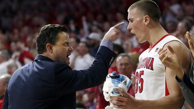 Arizona coach Sean Miller, left, talks to Kaleb Tarczewski during the first half of an NCAA college basketball game against Oregon. Rick Scuteri / AP Photo