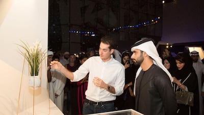 Hamza Al Omari gets a close up look at the artwork Nest. Courtesy The Cultural Office of HH Sheikha Manal bint Mohammed bin Rashid Al Maktoum