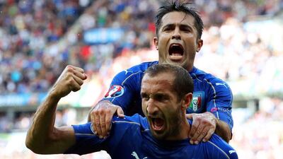 Italy's Giorgio Chiellini celebrates with teammate Eder after scoring the opening goal against Spain in their Euro last-16 match on Monday. Srdjan Suki / EPA