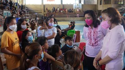 Philippine Vice President Leni Robredo, second from right, talks to people who were forced to flee their homes because of the storm. AP