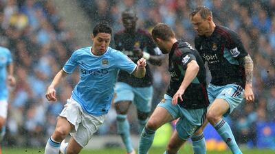 Samir Nasri of Manchester City competes with Matt Taylor, right, and George McCartney of West Ham United during their Premier League contest on Sunday. Alex Livesey / Getty Images