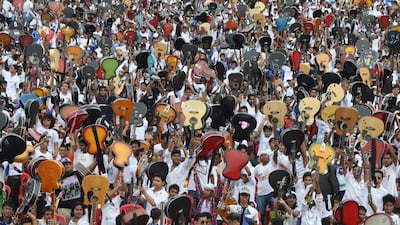 Guitarists raise their instruments after establishing a Limca record for the largest guitar ensemble (with 5,406 players), in Guwahati, India, June 2012. But the popularity of guitar music is on the wane in India. AFP