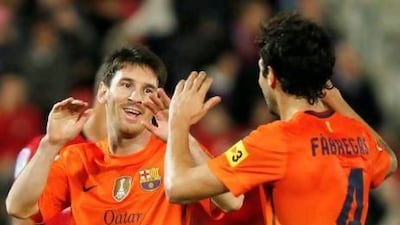 Lionel Messi, left, is just nine goals shy of equalling Gerd Muller's record of 85 in a calendar year. Enrique Calvo / Reuters