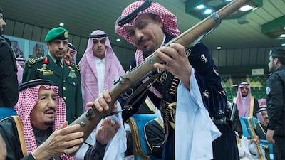 King Salman of Saudi Arabia check out a gun at the Janadriyah cultural festival in Riyadh on February 20, 2018. Bandar Algaloud / Courtesy of Saudi Royal Court / Reuters
