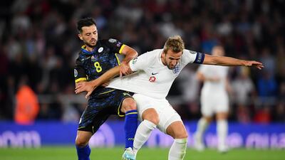 Harry Kane of England vies for the ball with Besar Halimi of Kosovo.