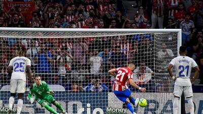 Atletico Madrid's Yannick Carrasco scores from the penalty spot. AFP