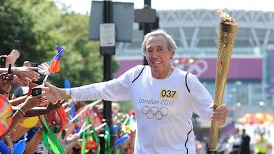Gordon Banks carries the Olympic Flame along Wembley Way during the London 2012 Olympic Torch Relay. Getty Images