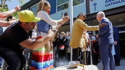 People react as Britain's Prince Charles speaks with indigenous drummer, Okimajd Anderson, during a visit to Assumption Elementary School, on the second day of the Canadian 2022 Royal Tour, in Vanier, Ottawa. Reuters