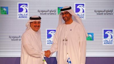 Sultan Ahmed Al Jaber, right, UAE Minister of State and director-general and CEO of Adnoc, shakes hands with Amin Nasser, president and CEO of Saudi Aramco. Ali Haider / EPA