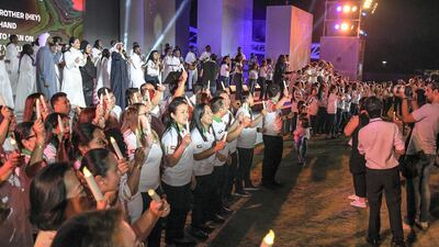Visitors hold candles aloft in a show of global solidarity.