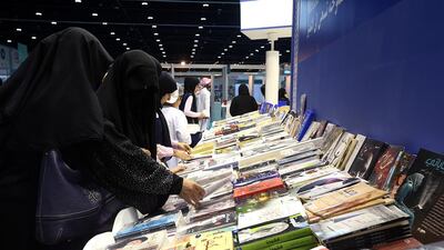 Visitors enjoy last year's Abu Dhabi International Book Fair at ADNEC in Abu Dhabi. Satish Kumar / The National