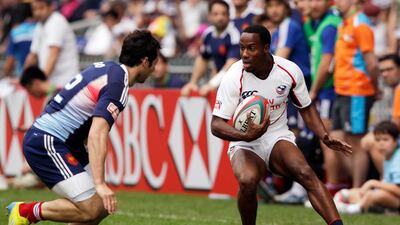 Carlin Isles of the U.S. (R) is blocked by France's Vincent Inigo during their preliminary match at the Hong Kong Sevens rugby tournament in Hong Kong March 23, 2013. REUTERS/Bobby Yip (CHINA) *** Local Caption *** HKG02_HONGKONG_0323_11.JPG