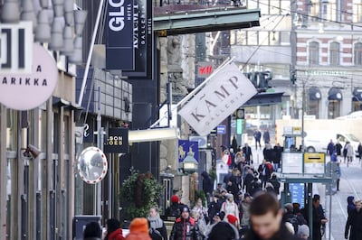 Pedestrians walk along Aleksanterinkatu, the main shopping street, in Helsinki, Finland. The Finns are exploring high-tech paths towards educating citizens on how to use their money. Bloomberg