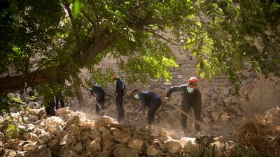 Rescuers dig for bodies at a mass grave in Raqqa, Syria in 2019. Qatari agents say they have found the remains of 30 people in a new US-backed search for ISIS victims. AP