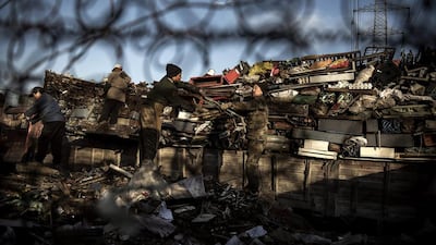 Chinese labourers load scrap metal onto a truck to be recycled in the Dong Xiao Kou village. Kevin Frayer / Getty Images