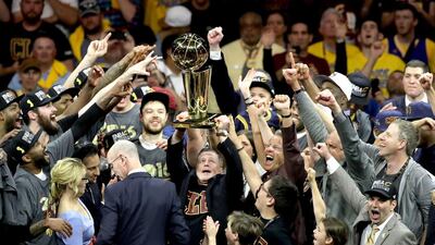 Cleveland Cavaliers owner Dan Gilbert holds the Larry O’Brien Championship Trophy after the Cavaliers defeated the Golden State Warriors 93-89 in Game 7 of the NBA Finals at ORACLE Arena on Sunday night in Oakland, California. Ronald Martinez / Getty Images / AFP