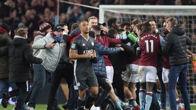 Leicester City's Youri Tielemans walks past Aston Villa fans and players in celebration. Reuters