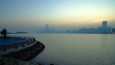 The sun rises on a foggy Wednesday morning at the Corniche. Victor Besa / The National