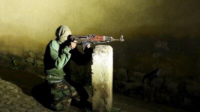 An armed vigilante holds an AK-47 rifle in the centre Bujumbura, Burundi, November 20, 2015. Picture taken November 20, 2015. REUTERS/Goran Tomasevic
