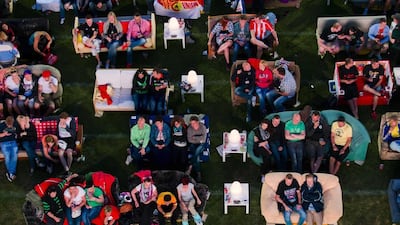 People sit on sofas as they watch the opening game of the 2014 World Cup at the Alte Forsterei in Berlin, Germany. Thomas Peter / Reuters