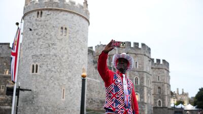 A man in a Union Jack suit takes a selfie outside Windsor Castle ahead of US President Donald Trump and first lady Melania Trump's arrival in Windsor, Britain. Reuters