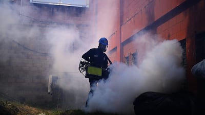 A municipal worker disinfects a quarantined homeless shelter in El Salvador's capital San Salvador. AFP
