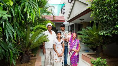 Vasundhara Yadav, front centre, with (from left) her father Ashok Yadav, brother Ravi, holding his four-month-old daughter Sandhiya, and sister-in-law Pinky outside Harmony House. Vasundhara and her sister Purti have begun studying at the shelter, where t???