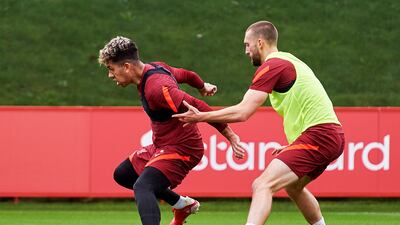 Roberto Firmino and Nathaniel Phillips of Liverpool during a training session at AXA Training Centre. All photos by Getty Images