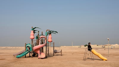 Tarek Al-Ghoussein sits on top of a slide in an empty children’s playground in a photograph from his Abu Dhabi Archipelago series in 2015. Photo: The Third Line