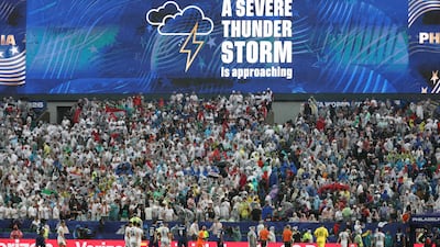A thunderstorm warning on the big screen in Philadelphia as rain begins during the match between Iraq and France. AFP