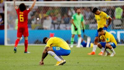 Brazil's Neymar and his teammates look dejected as Belgium's Axel Witsel celebrates. Reuters