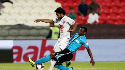 Baniyas defender Abdulsalam Al Mukhaini, right, fouls Al Jazira striker Ali Mabkhout in the penalty area during their Arabian Gulf League match at the Mohammed bin Zayed Stadium in Abu Dhabi on April 27, 2014. Christopher Pike / The National