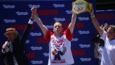 After winning first place for eating 63 hot dogs in 10 minutes, Mr Chestnut was awarded a trophy belt. AFP
