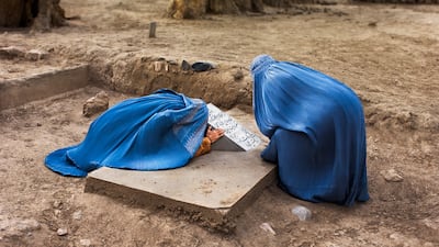 'Two Women Mourn in Cemetery. Bamiyan, Afghanistan, 2007'.