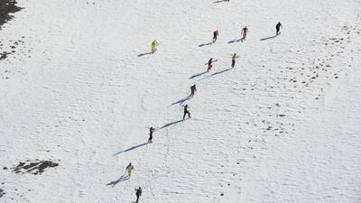 Participants make their way up the mountain after the start of the 2021 Afghan Mountain Challenge. Rick Findler for The National