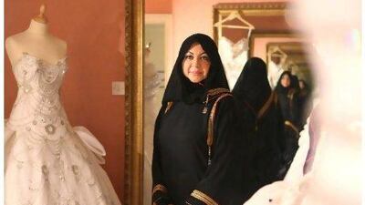 Mona Al Mansouri, the designer and owner of Al Mansouri Fashion, among some of her creations.
