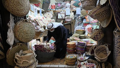 A vendor selling traditional baskets sorts his stock at Kuwait City's Souk Al Mubarakiya. EPA