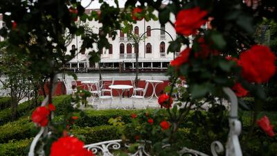 Rose bushes frame an empty garden overlooking a canal at the Ca' Nigra lagoon resort hotel along the canal grande in Venice, Italy. AP Photo / Antonio Calanni