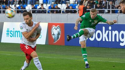 Ireland's James McClean, right, puts in a cross against Georgia. AP