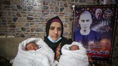 Palestinian Rasmia Hmaid with her twins Hani and Hammam at their family home in Gaza City. Photo: Majd Mohamad for The National
