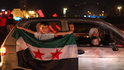 People celebrate in Damascus's Omeyyad square US President Donald Trump's decision to lift sanctions in Syria, on May 13. AFP