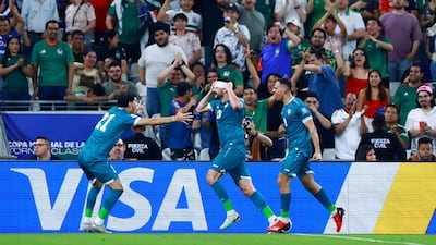 Iraq's Aymen Hussein celebrates scoring their second goal with teammates. Reuters