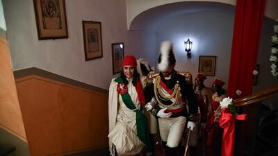 People reenacting the medieval revolt walk up the stairs of the city hall. AFP