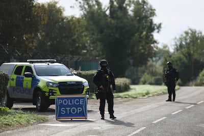 Armed police outside RAF Fairford following the initial arrests near the base. EPA