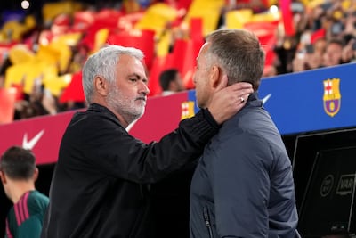 Real Madrid boss Jose Mourinho, left, embraces Barcelona counterpart Hansi Flick. Getty Images