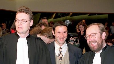 Belgian football player Jean-Marc Bosman, centre, flanked by his two lawyers, after the European Court of Justice ruled in 1995 that the transfer system of players between football clubs was illegal. AFP